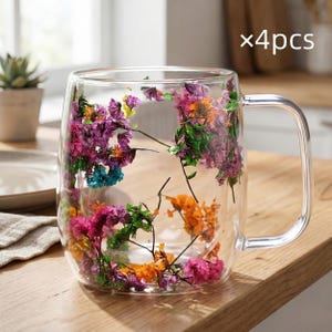 May include: A clear glass mug with a handle, filled with colorful dried flowers. The flowers are in shades of purple, pink, orange, and green. The mug is sitting on a wooden surface. The text "x4pcs" is visible in the top right corner.