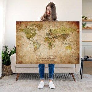 May include: A large rectangular world map with a vintage-style aged paper texture in shades of brown, tan, and muted green. The map features detailed geographical labels and the text "The Johnson Family Adventures" printed in a decorative script font.