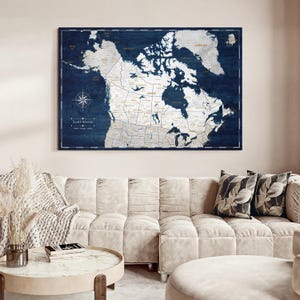 May include: A rectangular wall map of North America featuring a dark navy blue wood grain background with white landmasses. The map displays political boundaries, geographic labels, and a compass rose in the lower left corner with text.