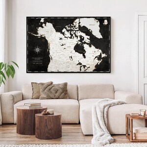 May include: A large rectangular wall map of Canada featuring a high-contrast design with a black background and white landmasses. The map includes detailed provincial borders, major cities, a compass rose, and text labels for geographical locations.