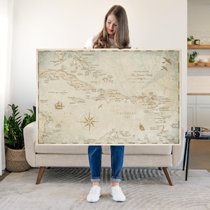 May include: A large rectangular wall map of the Caribbean Sea featuring a vintage-style beige background with dark brown text and illustrations. The map displays islands, nautical compass rose, sailing ship, and birds, with the text The Travels of The Johnson Family.