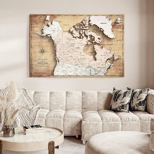 May include: A rectangular wall map of Canada featuring a vintage-style beige and brown background with dark brown landmass shading. The map displays provincial borders, major cities, and bodies of water, with the text Adventure Awaits printed.