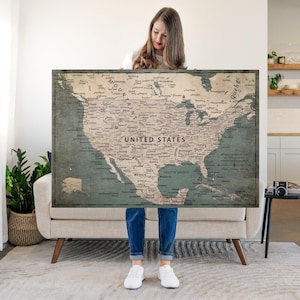 May include: A rectangular wall map of North America featuring a muted color palette of beige and dark teal. The map displays the United States, Canada, and Mexico with clearly labeled cities, states, provinces, and the text United States.