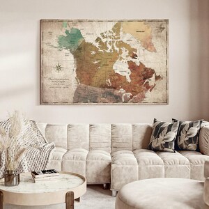 May include: A rectangular wall map of Canada featuring a vintage aesthetic with muted earth tones, including shades of green, brown, and tan. The map displays geographical labels, a compass rose, and the text "I have been everywhere but it is on my list."