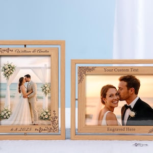 May include: Two wooden photo frames with engraved floral corner designs. One frame displays a wedding photo with the names "William & Amelia" and the date "6.8.2025". The other frame has the text "Your Custom Text" and "Engraved Here".