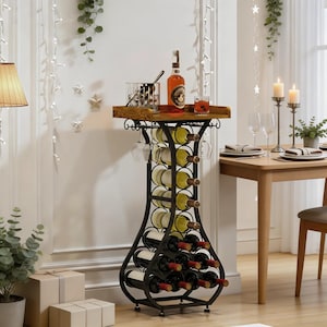 May include: A black metal wine rack with a wooden top, holding wine bottles and glasses. The rack has a decorative design and is placed near a dining table. A bottle of liquor and a cocktail are on the top shelf.