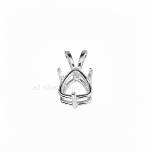 May include: A silver-colored pendant setting with a triangular design, featuring a prong setting to hold a gemstone. The setting has a loop for a chain and the text "All Silver Mount".