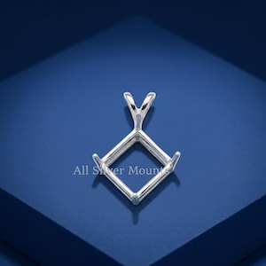 May include: A silver pendant setting with a square design and a bail. The setting has four prongs to hold a gemstone. The text "All Silver Mounts" is visible on the bottom left.