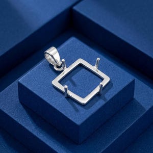May include: A silver-toned metal pendant setting featuring a square frame with four upright prongs at each corner, designed to hold a gemstone. The pendant includes a polished bail at the top for attachment to a chain or necklace cord.