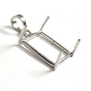 May include: A silver pendant setting with a rectangular design. The setting has four prongs and a loop for a chain. The pendant is designed to hold a gemstone or other decorative element. The setting is on a white background.