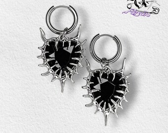 Brincos de argola Nevermore: argolas em aço inoxidável, pingentes em liga de zinco com design de estrela pontiaguda e gemas pretas.