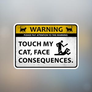 May include: A rectangular sticker with a yellow and black border. The top section reads "WARNING" with cat silhouettes. The text "TOUCH MY CAT, FACE CONSEQUENCES" is below, accompanied by a stick figure illustration.