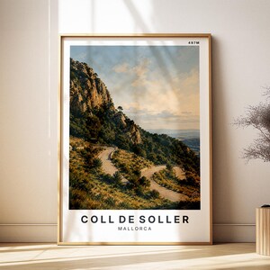 May include: A framed print featuring a scenic view of Coll de Soller in Mallorca. The image showcases a winding road through a mountain landscape with lush greenery and a cloudy sky. The print is in a gold frame and includes the text "COLL DE SOLLER MALLORCA".