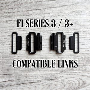 May include: Black FI SERIES 3 / 3+ compatible links. The image shows two sets of black metal links with the text "A12-523" and "A11-522" printed on them. The words "COMPATIBLE LINKS" are also displayed.