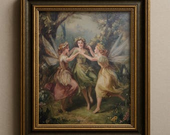 May include: A framed oil painting depicting three winged figures with floral crowns dancing in a circle within a forest setting. The figures wear flowing dresses in shades of pink, green, and yellow. The frame is dark wood with gold trim.