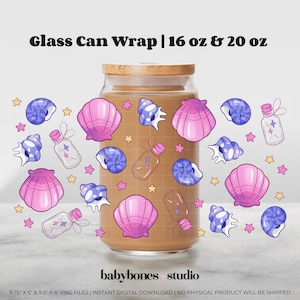 May include: A glass can wrap with a wooden lid, decorated with pink seashells, blue spiral shells, small bottles, and yellow stars. The text "Glass Can Wrap | 16 oz & 20 oz" is at the top. The "babybones studio" logo is at the bottom.