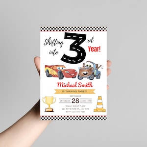 May include: A birthday invitation with cartoon car illustrations and the text "Shifting into 3rd Year!" The invitation includes the name "Michael Smith" and event details. The design incorporates a checkered flag border and racing-themed graphics.