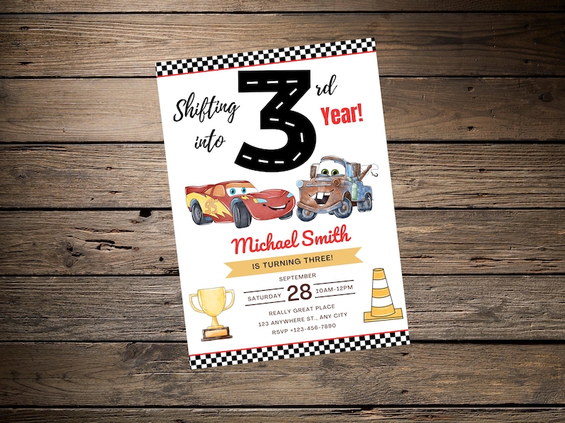 May include: A birthday invitation with cartoon car illustrations, a trophy, and a traffic cone. The text reads "Shifting into 3rd Year!" and includes party details. The invitation is on a wooden background.