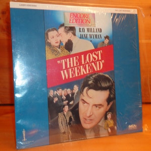 May include: A blue and red laserdisc case with a picture of Ray Milland and Jane Wyman from the movie "The Lost Weekend". The case is labeled "Encore Edition" and "The Lost Weekend".