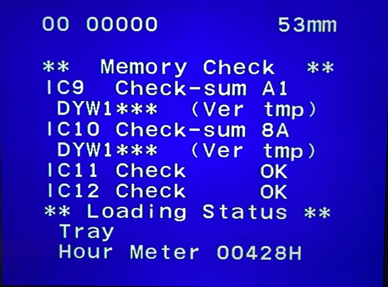 May include: A blue screen displays technical data. Text includes "Memory Check," "Check-sum," and "Loading Status." The screen also shows "53mm" and a reading of "Hour Meter 00428H."