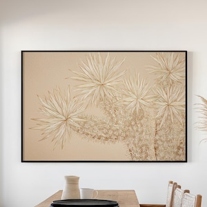 May include: A dining room scene featuring a large wooden table with a bench and woven chairs. A framed botanical print hangs above the table. A vase of pampas grass sits on a white pedestal, enhancing the room's neutral color palette.