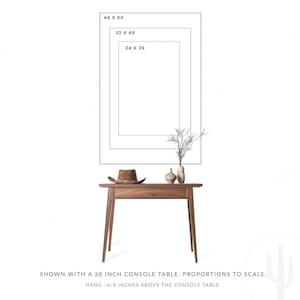 May include: A wooden console table with a drawer, topped with a brown hat, two vases, and a sprig of branches. Above the table are three rectangular outlines labeled 24 x 36, 32 x 48, and 40 x 60. Text reads: Shown with a 96.5 cm console table.