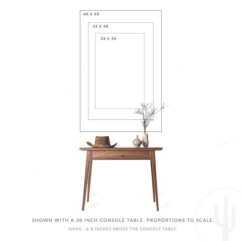 May include: A wooden console table with a drawer, topped with a brown hat, two vases, and a sprig of branches. Above the table are three rectangular outlines labeled 24 x 36, 32 x 48, and 40 x 60. Text reads: Shown with a 96.5 cm console table.
