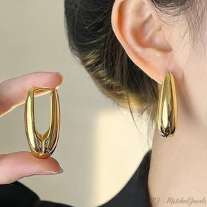Orecchini a cerchio ovali massicci: gioielli pendenti moderni e audaci, eleganti in argento e oro