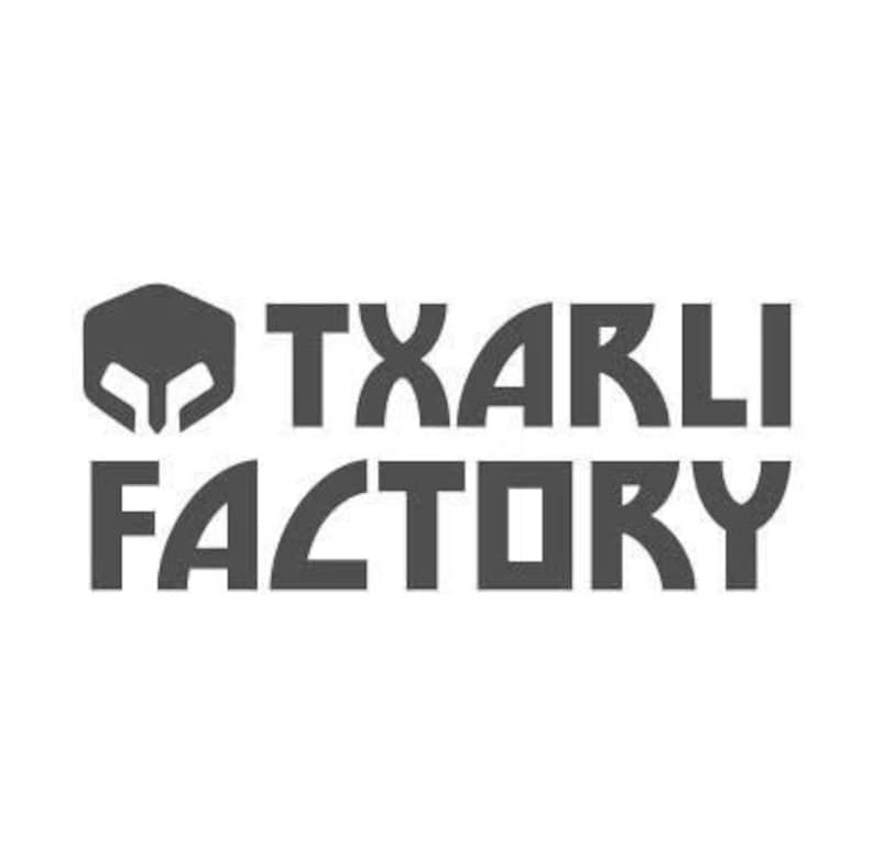 May include: A gray logo featuring a stylized helmet icon and the text "TXARLI FACTORY" in a bold, sans-serif font. The design is simple and modern, suitable for branding.