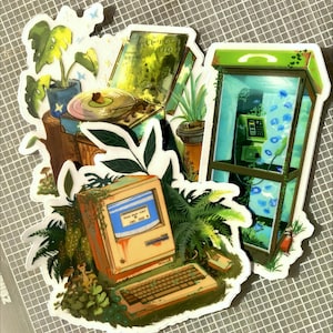 May include: A collection of stickers featuring vintage-style illustrations. The stickers depict a record player, a telephone booth, and an old computer, all surrounded by lush greenery and plants. The computer screen reads "TURN BACK TIME".