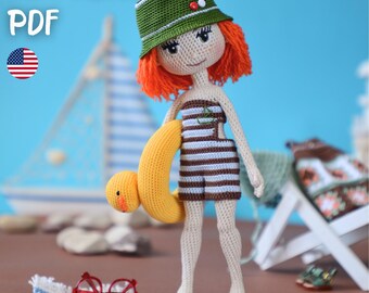 May include: A handmade crochet doll with red hair, wearing a green hat, striped swimsuit, and orange sandals, holding a yellow inflatable ring. The doll is standing on a beach with a sailboat and the text "PATTERN PDF" in the background.