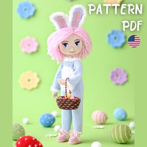 May include: A crocheted doll wearing a blue bunny costume with pink hair and bunny ears, holding a basket. The doll is surrounded by crocheted Easter eggs and flowers. The image includes the text "PATTERN PDF" and an American flag.
