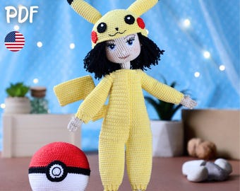 May include: A handmade crochet doll wearing a yellow Pikachu costume with a matching hat and tail. The doll has black hair and blue eyes. A red and white crochet Pokeball sits next to the doll. The image includes the text "PATTERN PDF" and an American flag.
