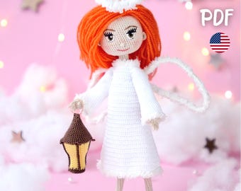 May include: A handmade crochet angel doll with orange hair, white dress, and wings, holding a brown and yellow lantern. The doll has a halo and is standing on a pink background with the text "PATTERN PDF".