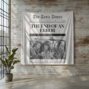 May include: A white wall tapestry with the headline "The Toxic Times" and the text "The End of an Error." Below the headline is a black and white photo of three women. The text "We Never Liked Him Anyways" is at the bottom.
