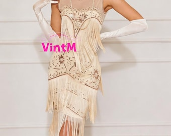May include: A cream-colored flapper dress with intricate beadwork and fringe detailing. The sleeveless dress features a sheer neckline and a layered skirt with long fringe. The dress is accessorized with long white gloves and a pearl necklace. The dress has a vintage aesthetic.
