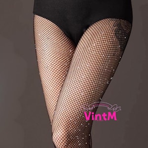 May include: Black fishnet stockings with scattered rhinestone embellishments. The stockings are worn with a black leotard. The image is set against a neutral gray background. The brand name "VintM" is visible in the lower right corner.