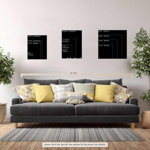 May include: A dark gray sofa with yellow and patterned throw pillows positioned below three black rectangular wall art displays. Each display features white text listing various dimensions in inches and centimeters, including 4x6, 12x16, 18x20, 5.8x8.3, 8.3x11.7, 11.7x16.5, 16.5x23.4, 12x12, 16x16, 20x20, and 24x24 inches.