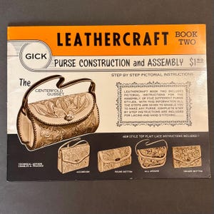 May include: A rectangular instructional book titled LEATHERCRAFT BOOK TWO PURSE CONSTRUCTION and ASSEMBLY. The cover features an orange header, black text, and illustrations of five different leather purses with floral tooling and lacing details.