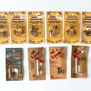 May include: A collection of woodburning tools and replacement tips. The packages feature text like "The Creative Woodburner" and "Walnut Hollow Farm." The tools are in various shapes and sizes, with some packaged in clear tubes.
