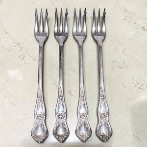 May include: A set of three ceramic mugs with a speckled, matte finish. The mugs are in shades of cream, light gray, and dark gray. Each mug has a simple, minimalist design, perfect for coffee or tea.