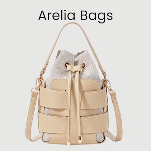 Peut inclure: Un sac seau beige avec un intérieur tissé et un extérieur structuré avec un design unique. Le sac a une poignée supérieure et une bandoulière amovible. Le texte "Arelia Bags" est affiché en haut.