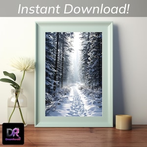 Peut inclure: Une impression encadrée d'une forêt enneigée. L'image montre un sentier serpentant à travers des arbres couverts de neige, avec la lumière du soleil filtrant à travers. Le cadre est vert clair, avec le texte "Instant Download!" en haut.