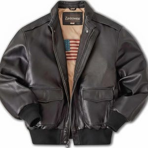 May include: A black leather bomber jacket with a zip-up front, two front pockets, and a ribbed hem and cuffs. The jacket has a tan lining with an American flag design and the brand name "ZaviroWear" on the label.