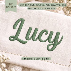 May include: An embroidery font design featuring the name Lucy in a dark green thread on a light beige fabric background. The text includes file formats DST, EXP, HUS, JEF, PEC, PES, SEW, VP3, XXX, and indicates 6 sizes from 2.54 to 8.89 cm.
