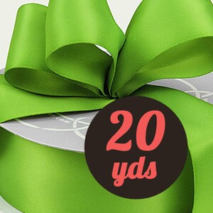 May include: A roll of 20 yards of bright green satin ribbon. The ribbon is tied into a bow and displayed on a spool.