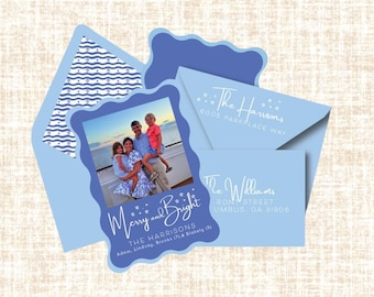 May include: Light blue holiday card set with a family photo, the words "Merry and Bright", and family names. Includes a patterned envelope and an address card. The set is designed for Christmas or other winter holidays.