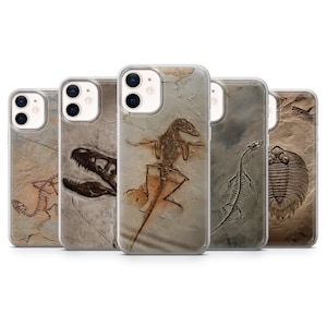 May include: A collection of clear phone cases featuring fossil designs. The cases display various prehistoric creatures, including dinosaur skeletons and a trilobite, in shades of brown and gray against a textured background.
