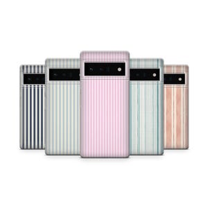 May include: Five phone cases with vertical striped patterns in various colors: navy blue, light blue, pink, teal, and peach. The cases have a rectangular camera cutout and a small dot for the flash.