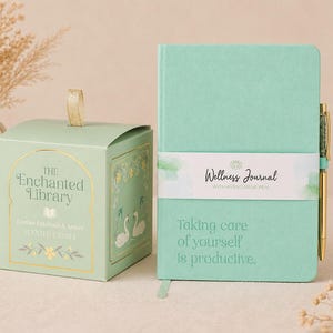 May include: A mint green gift set with a candle and a journal. The candle is in a decorative box with gold accents and the text "The Enchanted Library". The journal has a white band with the text "Wellness Journal". The journal also has the text "Taking care of yourself is productive."
